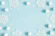 © Flaffy - Christmas or winter composition. Pattern made of white balls and snowflakes on pastel blue background. Christmas, winter, new year concept. Flat lay, top view, copy space