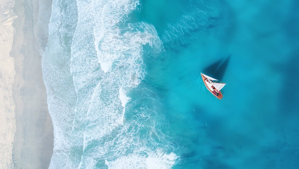Wall Mural - yacht on the water surface from top view. turquoise water background from top view. summer seascape 