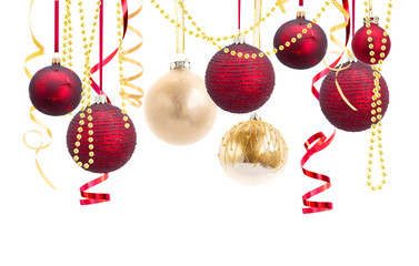 Canvas Print - Row of red and golden christmas balls with curling paper isolated over white background