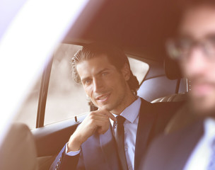 Wall Mural - businessman sitting in his car.