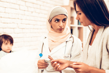 Wall Mural - Portrait Arabic Female Doctor Holding Medicament