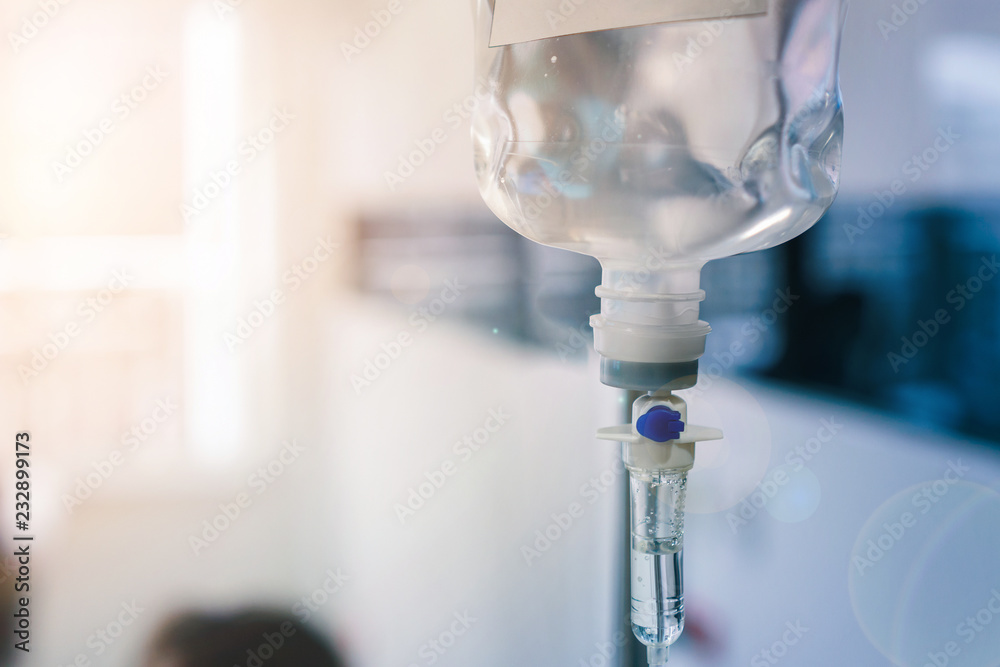 Healthcare concept, Close up of medical drip or IV drip chamber in patient room, Selective focus. - obrazy, fototapety, plakaty 