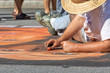 © john - Male artist drawing with chalk on street during autumn festival.