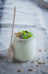 Wall Mural - Homemade granola with greak yogurt in a glass jar. Healthy food concept