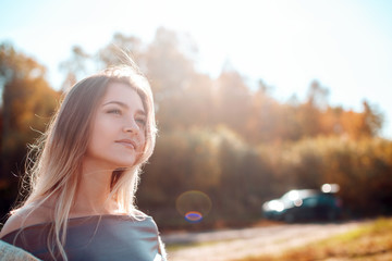 Poster - Pretty girl posing on camera and enjoying sunny autumn day.