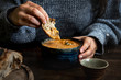 © Rawpixel.com - Woman dipping bread into a pumpkin soup