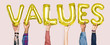 © Rawpixel.com - Hands holding values word in balloon letters