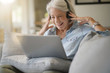 © goodluz - Senior woman at home on laptop