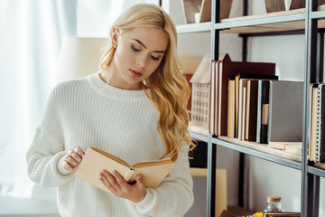 Wall Mural - close up of beautiful woman reading book near rack