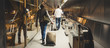 © simona - Crowd of men and women inside the airport gate moving to start or just arrived. People walking with hand bag and luggages and trolley with wheels. Travelers around the world concept