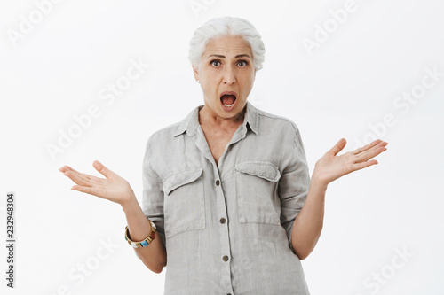 Studio Shot Of Confused And Displeased Shocked Senior Mother With