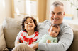© Syda Productions - family, fatherhood and people concept - happy father with preteen and baby son at home