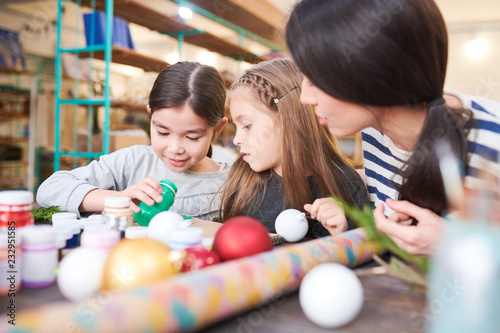 Fotografie, Obraz Portrait of two little kids making Christmas decorations in crafting class with
