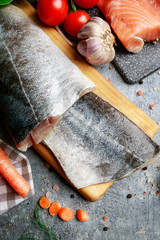 Poster - Raw fishes and vegetables on stone background