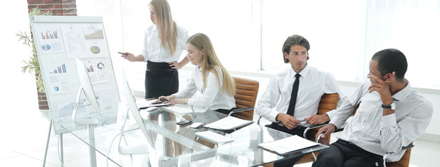 woman presenting her idea to colleagues at meeting