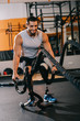 © LIGHTFIELD STUDIOS - handsome young sportsman with artificial leg working out with ropes at gym