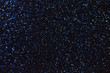 Blurred shiny navy blue background with sparkling lights.