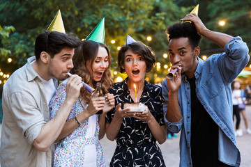 Group of cheerful multhiethnic friends celebrating