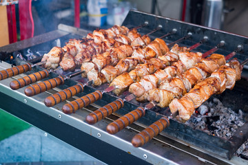 Marinated shashlik preparing on a barbecue grill over charcoal (skewered meat).