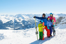 Happy Family Enjoying Winter Vacations In Mountains . Ski, Sun,Snow And Fun.