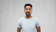 © Syda Productions - expression, rudeness and people concept - indian man making faces and showing his tongue over gray background