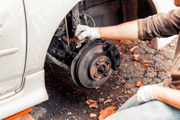 Wall Mural - Closeup of work on fastening the car shock absorber.