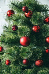 close up view of red christmas balls on christmas tree