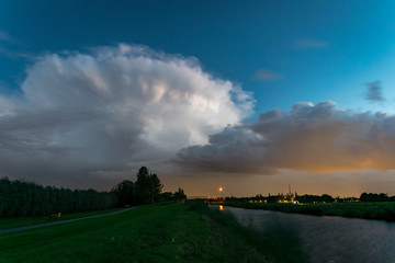 Wall Mural - an autumn thunderstorm moves over the dutch countryside at blue hour