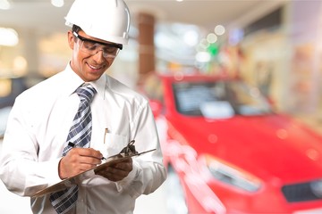 Young business man in suit and white helmet