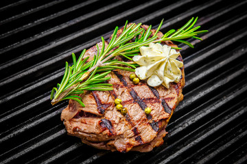 Wall Mural - grilling steaks on grill and shot with selective focus