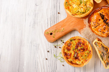 Wall Mural - Meat mini pie on the wooden board on white table background, closeup with copy space, rustic style