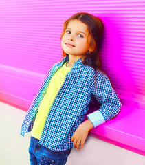 Portrait beautiful little girl child on colorful pink wall background