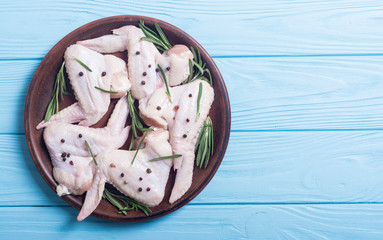 Wall Mural - Chicken raw wings with rosemary , garlic , pepper and salt