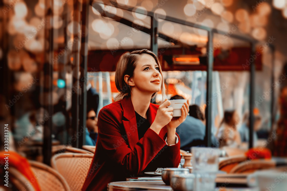 Style redhead girl in red coat with cup of coffee in parisian cafe. Autumn season time - obrazy, fototapety, plakaty 