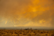 A raging wildfire rips through the Sierra Nevada mountains in California, turning the sky into a blaze of orange smoke
