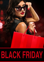 Wall Mural - Black friday sale concept. Shopping woman in sunglasses holding bag on background with bokeh lights in holiday