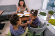 © zinkevych - Scolding for behavior. Dark-haired caring mother scolding her little girls for bad behavior in restaurant