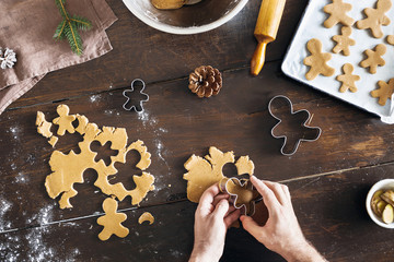 Poster - Christmas food Man cooking gingerbread cookies top view Xmas dessert