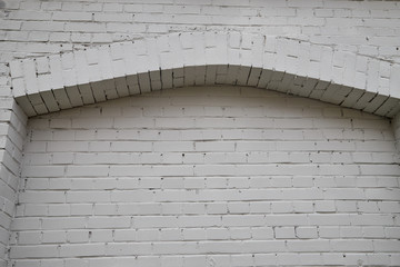  Large white brick wall with arch. Bottom view