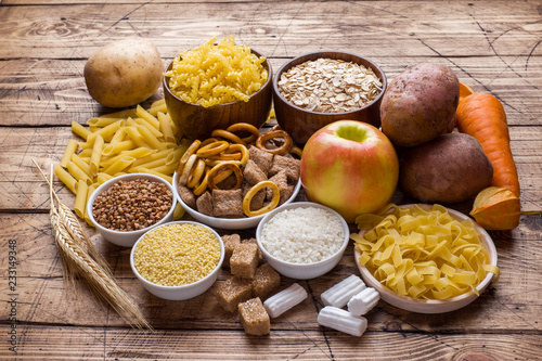 Fotografía Foods high in carbohydrate on rustic wooden background.