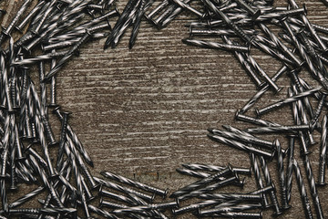 Wall Mural - Top view of nails arranged on wooden table