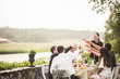 © Maskot - Friends toasting wineglasses during dinner party in backyard