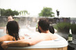 © Maskot - Male and female friends enjoying in hot tub during weekend getaway
