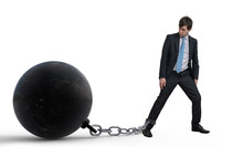 Young Businessman Has Chained Big Metal Ball To His Leg. Isolate