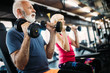 © NDABCREATIVITY - Fit senior sporty couple working out together at gym
