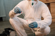 © LIGHTFIELD STUDIOS - cropped view of forensic investigator in latex gloves taking blood samples at crime scene