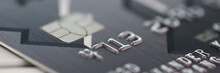 Embossed Chipped Credit Card Lying On Silver Keyboard