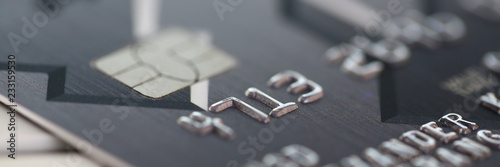 Fotografía Embossed chipped credit card lying on silver keyboard