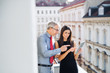 © Halfpoint - Man and woman business partners with tablet standing on a terrace in city, talking.