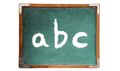 Fototapete - ABC alphabet letters text word message in white chalk written on a green old grungy vintage wooden chalkboard or blackboard with frame isolated on white background.